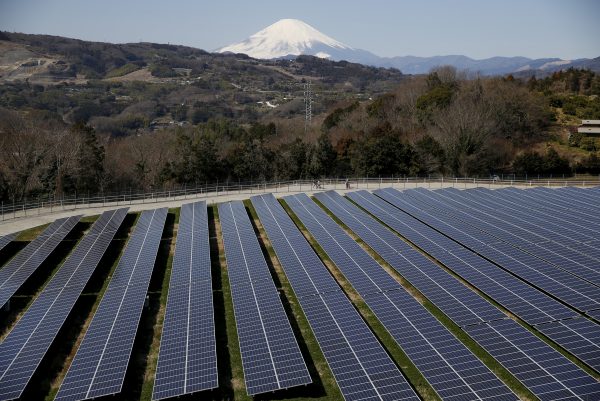 Solar panels are seen at a solar power facility as snow covered Mount Fuji is background in Nakai town, Kanagawa prefecture, Japan, 1 March, 2016 (Reuters/Kato).