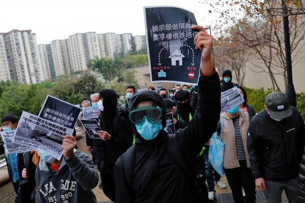 Residents wear facial masks as they march to protest against the government's plan to set up a quarantine site close to their community amid the Wuhan outbreak, in Hong Kong, China 2 February 2020 (Reuters/Tyrone Siu).