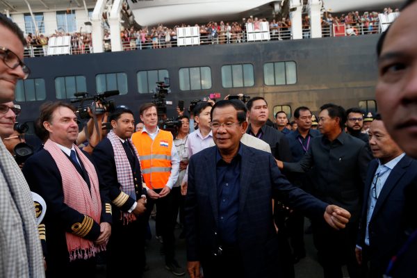 Cambodia's Prime Minister Hun Sen welcomes crews of MS Westerdam, a cruise ship that spent two weeks at sea after being turned away by five countries over fears that someone aboard might have the coronavirus, as it docks in Sihanoukville, Cambodia, 14 February 2020 (Photo: Reuters/Soe Zeya Tun).