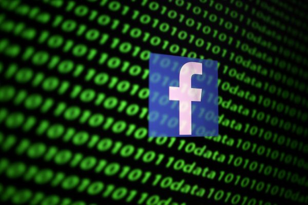 The Facebook logo and binary cyber codes are seen in this illustration taken, 26 November 2019 (Photo: Reuters/Dado Ruvic).