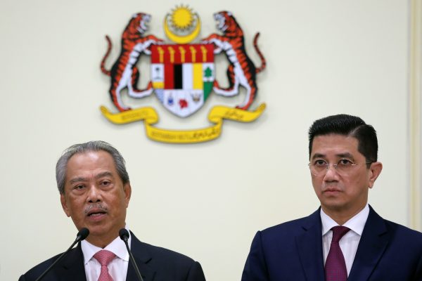 Malaysia's Prime Minister Muhyiddin Yassin speaks next to Minister of International Trade and Industry Azmin Aliduring a news conference in Putrajaya, Malaysia, 11 March 2020 (Photo: Reuters/Lim Huey Teng).