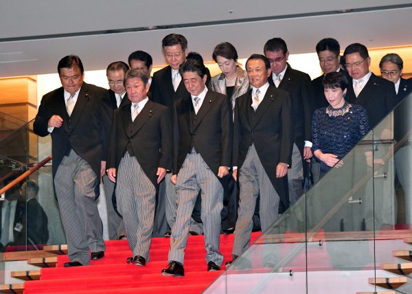 Japan's Prime Minister Shinzo Abe, centre, leads the way, coming down the stairs for an official photo session following the first meeting of his reshuffled Cabinet at the prime ministers office in Tokyo, Japan, 11 September 2019 (Photo: AFLO/Natsuki Sakai).