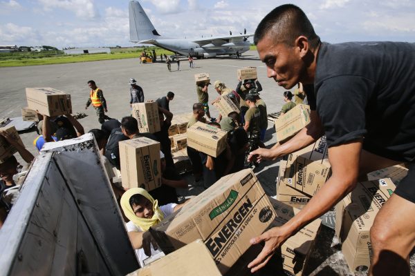 Philippine Army personnel unload relief goods to be transported to regions affected by Typhoon Bopha, from the Marine Corps KC-130J Hercules aircraft inside the International Airport in Davao, Mindanao 15 December, 2012 (Photo: Reuters/John Javellana).