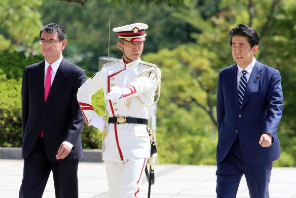 Japanese Prime Minister Shinzo Abe (R), accompanied by Defense Minister Taro Kono (L), reviews honor guards at Defense Ministry in Tokyo on Tuesday, 17 September 2019. (Photo by Yoshio Tsunoda/AFLO via Reuters).