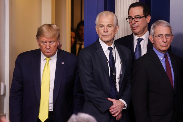US President Donald Trump walks towards White House trade adviser Peter Navarro, Treasury Secretary Stephen Mnuchin and Anthony Fauci, director of the NIH National Institute of Allergy and Infectious Diseases, as he arrives for the daily Coronavirus-related briefing at the White House in Washington DC, 9 March 2020 (Photo: REUTERS/Jonathan Ernst).