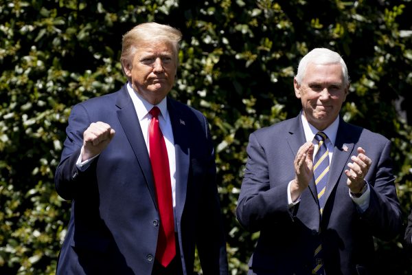 US President Donald J. Trump (L) gestures beside US Vice President Mike Pence (R) during a tree planting ceremony to commemorate Earth Day and Arbor Day, on the South Lawn of the White House in Washington, DC, USA, 22 April 2020 (Photo: Reuters).