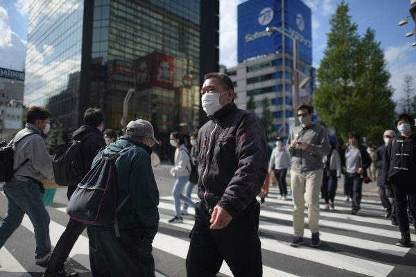 People wearing face masks are seen crossing the street at Akihabara district amid the coronavirus pandemic on Friday 24 April, 2020 in Tokyo, Japan. Japanese Prime Minister Shinzo Abe declared a State of Emergency on April 7th to stop the spread of the coronavirus throughout the country. (Photo: Reuters /Richard Atrero de Guzman).