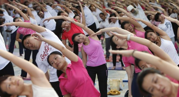 Participants exercise during Mega Yoga Day in Kuala Lumpur. The event, which aims to hold the largest gathering of yoga participation in Malaysia, also promotes national awareness of physical fitness and an active lifestyle through exercise, according to government organisers in Kuala Lumpur, Malaysia, 27 October 2013 (Reuters/Samsul Said).