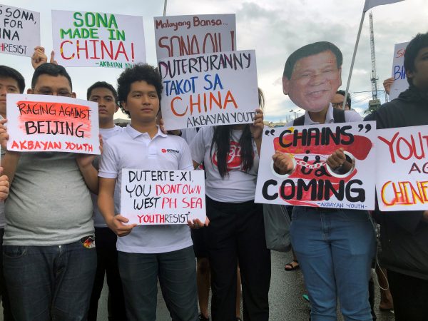 Filipino student activists hold placards against China during a protest against Duterte’s annual State of the Nation Address in Manila, Philippines, 22 July 2019 (Photo:Reuters/Peter Blaza).