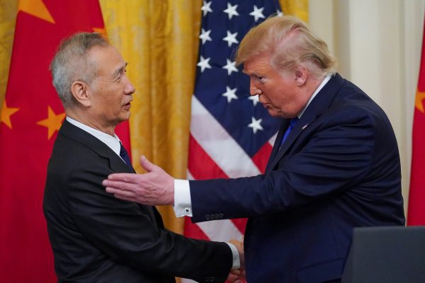 U.S. President Donald Trump applauds greets Chinese Vice Premier Liu He prior to signing 