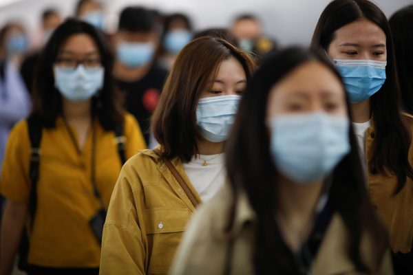 People wearing face masks walk inside a subway station during morning rush hour, following an outbreak of the coronavirus disease (COVID-19), in Beijing, China 11 May, 2020 (Photo: Reuters/Carlos Garcia Rawlins).