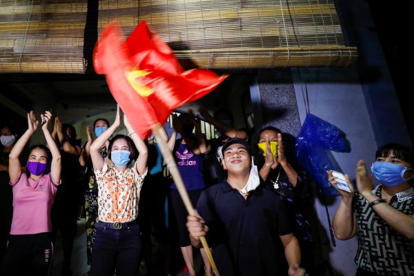 Residents celebrate after authorities lifted the quarantine in Dong Cuu village, the last Vietnamese quarantined village affected by COVID-19, outside Hanoi, Vietnam, 14 May 2020 (Photo: Reuters/Kham).