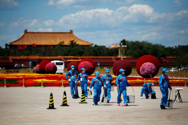 Sanitary workers wearing face masks following the COVID-19 outbreak are seen on Tiananmen Square before the closing session of the Chinese People's Political Consultative Conference (CPPCC) in Beijing, China, 27 May 2020 (Photo: Reuters/Thomas Peter).