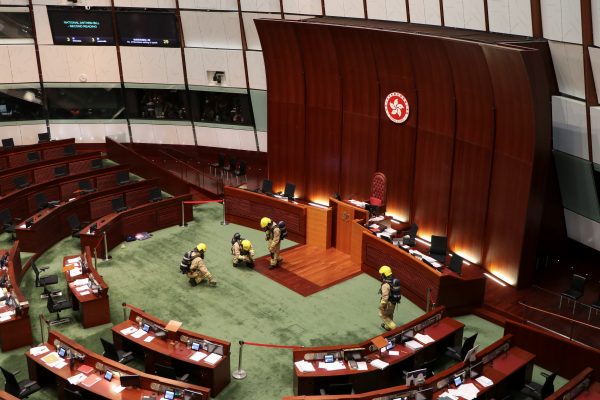 Firefighters wearing gas masks check the chamber of the Legislative Council in Hong Kong, China, 28 May 2020 (Photo: REUTERS/Jessie Pang).
