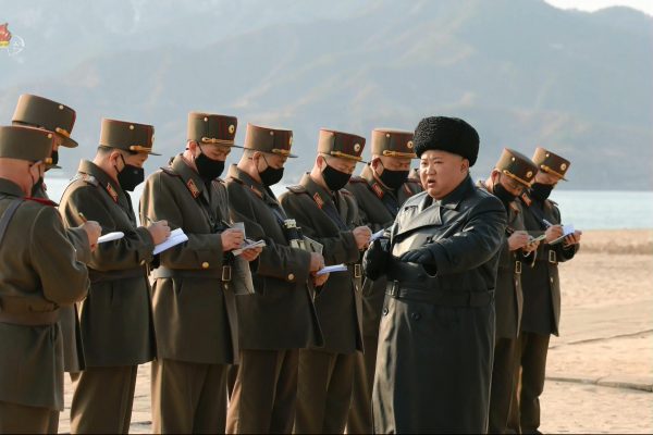 North Korean leader Kim Jong-un, the only one not wearing a coronavirus mask, watches his troops fire rockets and artillery shells, 13 March 2020 (Photo: Korean Central News Agency via Reuters).