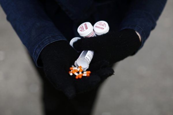 A fentanyl user displays a 'safe supply' of opioid alternatives, including morphine pills in the Downtown Eastside of Vancouver, British Columbia, Canada, 6 April 2020 (Photo: Reuters/Jesse Winter).