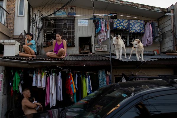 Girls hang out with their dogs on the roof of their house as the Philippine government enforces home quarantine to contain the coronavirus disease (COVID-19) outbreak in Metro Manila, Philippines, 21 April 2020. (Photo:Reuters/Eloisa Lopez).
