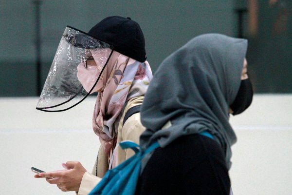 Women are pictured wearing a protective face mask and face shield as the Indonesian government eases coronavirus restrictions in Jakarta, Indonesia, 8 June 2020 (Photo: Reuters/Ajeng Dinar Ulfiana).