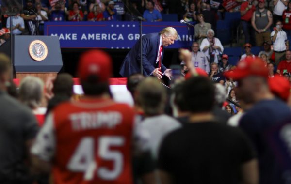 US President Donald Trump re-enacts his walking down a ramp at the end of a ceremony at West Point as he addresses his first re-election campaign rally in several months in Tulsa, Oklahoma, 20 June 2020 (Photo: REUTERS/Leah Millis).