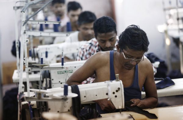 Employees sew clothes at a garment factory in New Delhi, India, 29 September 2014 (Photo: Reuters/Adnan Abidi).