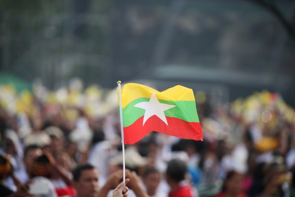 Person waving a Myanmar flag at Kyite Ka San Football Stadium in Yangon, Myanmar, 29 November 2017 (Photo: Reuters/Soe Zeya Tun).