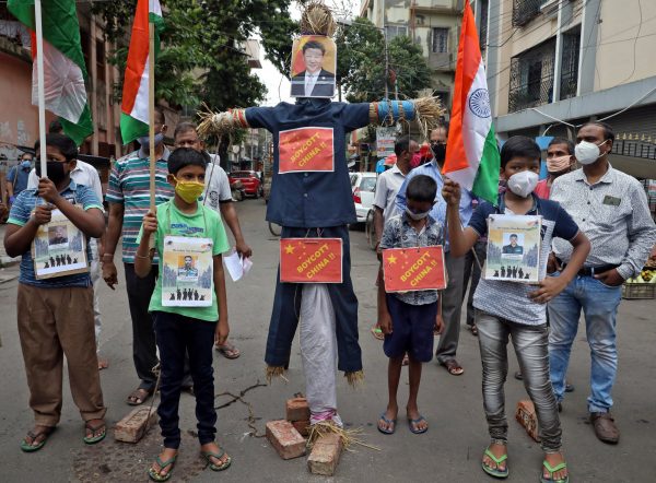 Demonstrators stand next to an effigy depicting Chinese President Xi Jinping before burning it during a protest against China, in Kolkata, India, 18 June 2020 (Photo: Reuters/Rupak De Chowdhuri).