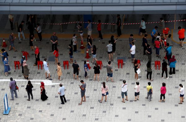 Voters practice social distancing while queuing at a polling station during Singapore's general election amid the COVID-19 outbreak, 10 July 2020 (Photo: Reuters/Edgar Su).