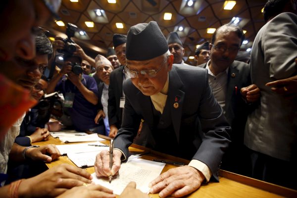 Prime Minister of Nepal and former Chairman of the Communist Party of Nepal (Unified Marxist-Leninist) (CPN-UML) Khadga Prashad Oli signs on the copy of constitution at the parliament in Kathmandu, Nepal, 18 September, 2015 (Reuters/Navesh Chitrakar).