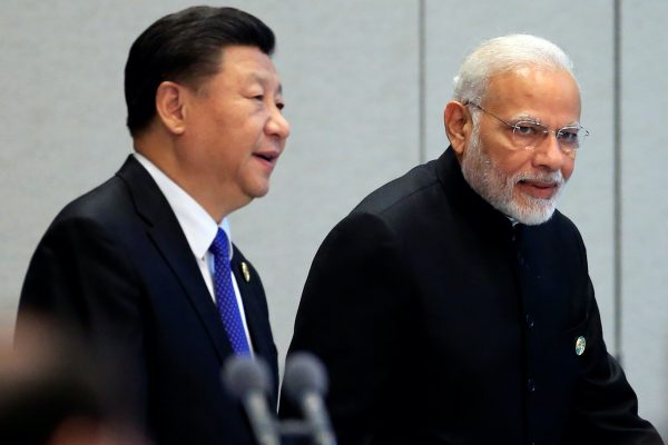 China's President Xi Jinping and India's Prime Minister Narendra Modi arrive for a signing ceremony during Shanghai Cooperation Organization (SCO) summit in Qingdao, Shandong Province, China, 10 June, 2018 (Reuters/Aly Song).