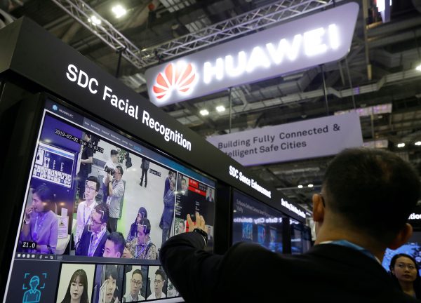 A Huawei employee showcases their facial recognition technology at their booth at Interpol World in Singapore, 2 July 2019 (Reuters/Edgar Su).