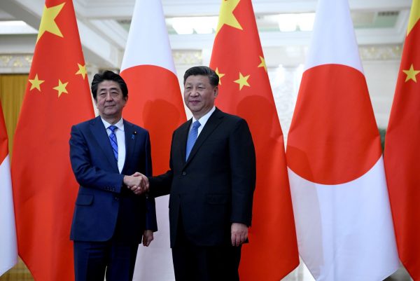 Japan's Prime Minister Shinzo Abe shakes hands with China's President Xi Jinping at the Great Hall of the People in Beijing, China, 23 December 2019 (Photo: Reuters/Noel Celis).