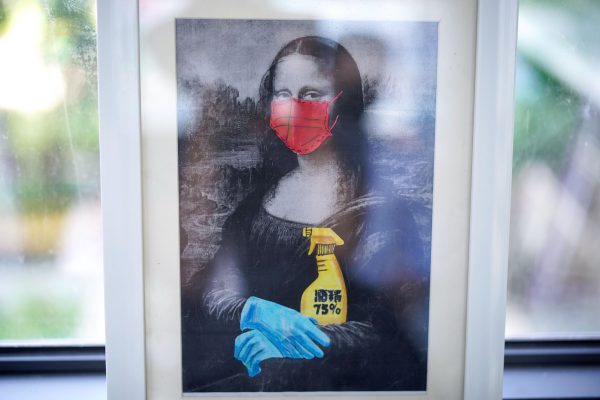 A painting depicting Mona Lisa wearing a face mask and gloves is pictured at Changchun Street Primary School of Wuhan during a government-organized media tour following the coronavirus disease (COVID-19) outbreak, in Wuhan, Hubei province, China, 4 September, 2020 (Reuters/Aly Song).