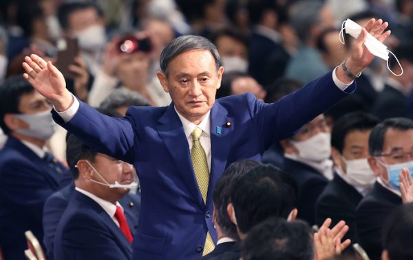 Japan's Chief Cabinet Secretary Yoshihide Suga waves his hands after winning in the LDP (Liberal Democratic Party) presidential election at a hotel in Minato Ward, Tokyo on September 14, 2020. Prime Minsiter Shinzo Abe will leave the prime minister post for his health problem and a ruling party President election took place on the same day (Photo: Reuters/The Yomiuri Shimbun).