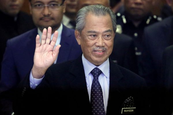 Malaysia's Prime Minister Muhyiddin Yassin waves to reporters before his cabinet announcement in Putrajaya, Malaysia, 9 March 2020 (Photo: Reuters/Lim Huey Teng).
