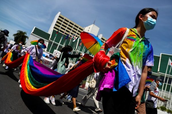 Members of a youth pride student group hold an LGBT flag during a rally for gender rights in Bangkok, Thailand 29 July, 2020 (Photo: Reuters/Athit Perawongmetha).