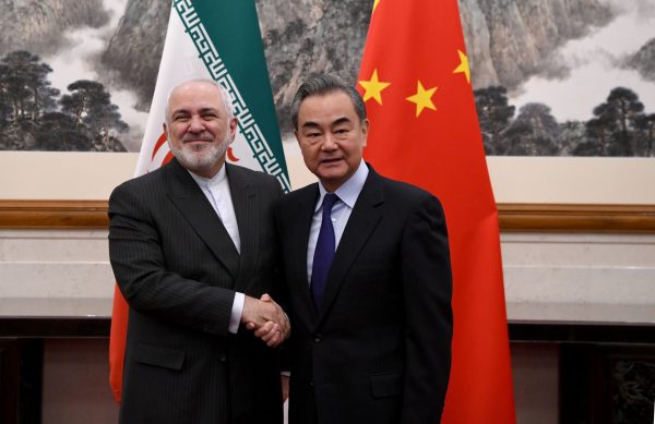 China's Foreign Minister Wang Yi shakes hands with Iran's Foreign Minister Mohammad Javad Zarif during a meeting at the Diaoyutai state guest house in Beijing, China, 31 December 2019 (Photo: Reuters/Noel Celis).