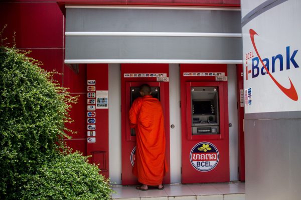 A monk withdraws money from an ATM in Vientiane, Laos (Photo: Reuters).