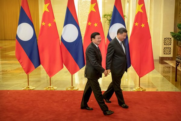 Laos' Prime Minister Thongloun Sisoulith and Chinese President Xi Jinping walk together before a meeting at the Great Hall of the People in Beijing, China, 6 January 2020 (Mark Schiefelbein/Pool via Reuters).