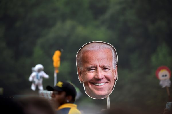 A reveler waves a cardboard cutout of former vice president Joe Biden in Dover, Delaware (Photo: Reuters/Mark Makela).