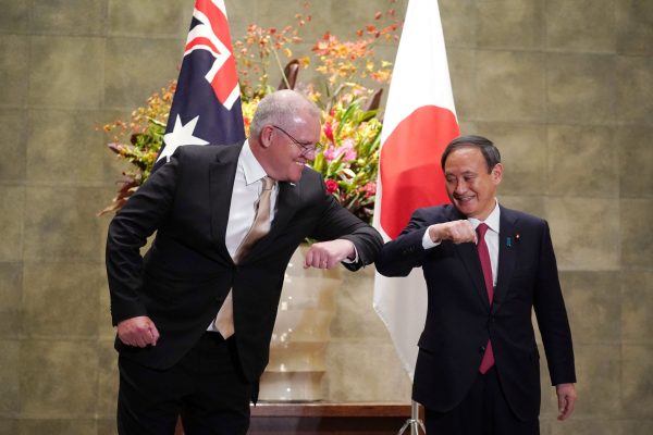 Australian Prime Minister Scott Morrison greets Japan's Prime Minister Yoshihide Suga prior to the official welcome ceremony at Suga's official residence in Tokyo, Japan, 17 November, 2020 (Photo: Eugene Hoshiko/Pool via Reuters).