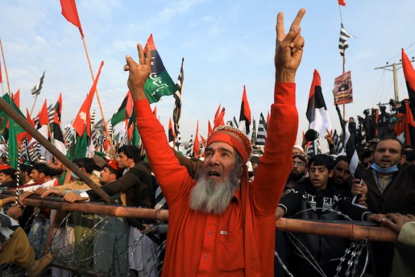 A supporter of the Pakistan Democratic Movement (PDM), an alliance of political opposition parties, chants slogans with others during an anti-government protest rally in Peshawar, Pakistan 22 November, 2020 (Photo: Reuters/Aziz).