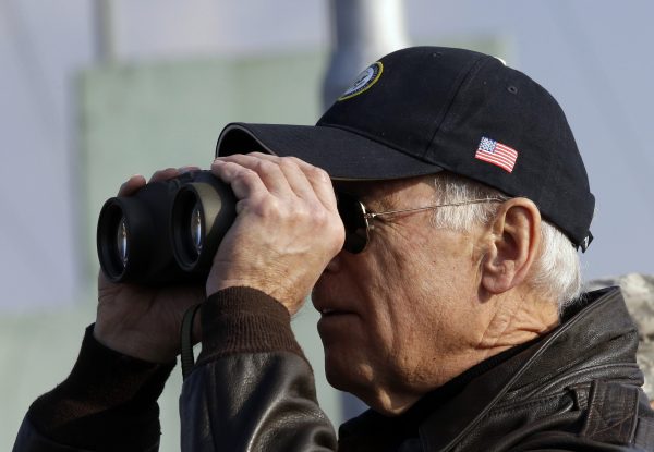Joe Biden looks through binoculars to see North Korea from Observation Post Ouellette during a tour of the Demilitarized Zone (DMZ), the military border separating the two Koreas, in Panmunjom, 7 December 2013 (Photo: Reuters/Lee Jin-man/Pool).
