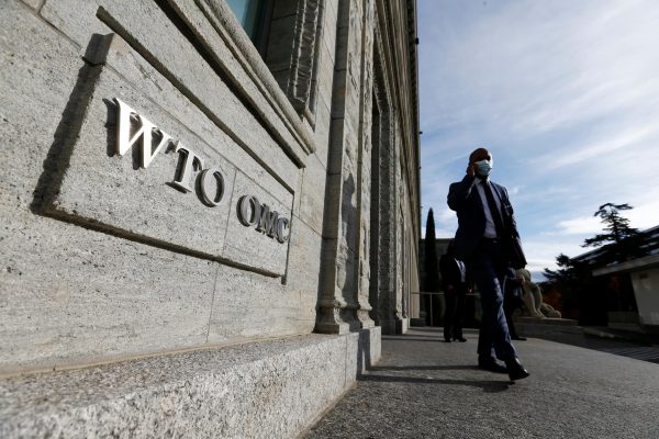 A delegate arrives before a meeting at the World Trade Organization (WTO) in Geneva, Switzerland, 28 October 2020. (Photo: Reuters/Denis Balibouse).