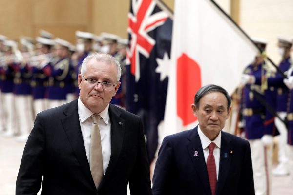 Australia's Prime Minister Scott Morrison and Japan's Prime Minister Yoshihide Suga review an honor guard during a ceremony ahead of a meeting at Suga's official residence in Tokyo, Japan, 17 November, 2020 (Photo: Kiyoshi Ota/Pool via Reuters).