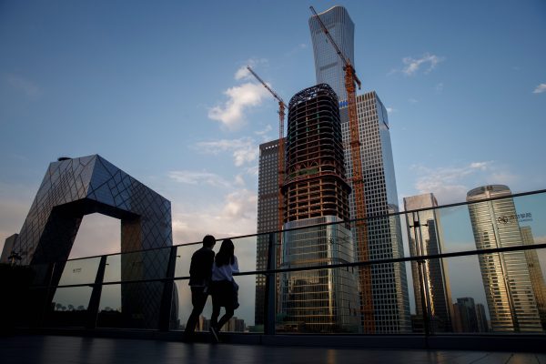 People look at the skyline of the Central Business District in Beijing, China, 16 April, 2020 (Photo: Reuters/Thomas Peter/File Photo).