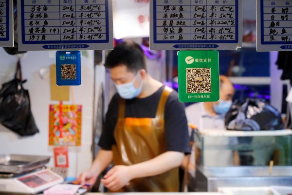 QR codes of the digital payment services WeChat Pay and its competitor Alipay are seen at a meat stall at a fresh market in Beijing, China 8 August 2020. (Photo: Reuters/Thomas Peter).