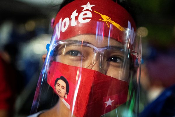 A supporter of the National League for Democracy party waits for results outside the party headquarters, after the general election in Yangon, Myanmar, 8 November 2020 (Photo: Reuters/Shwe Paw Mya Tin).