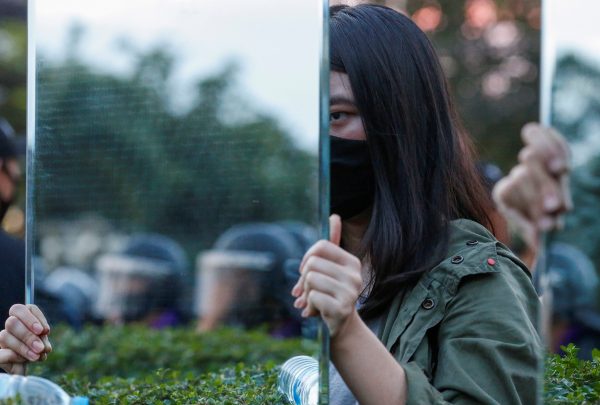 Protesters hold mirrors in front of riot police officers during a pro-democracy rally demanding the prime minister to resign and reforms on the monarchy, at 11th Infantry Regiment, in Bangkok, Thailand, 29 November 2020 (Photo: Reuters/Soe Zeya Tun).