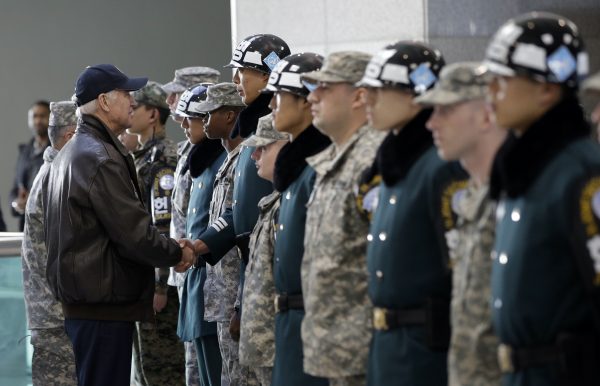 Former US vice president Joe Biden (front, L) shakes hands with South Korean and US soldiers during a tour of the Demilitarized Zone (DMZ), the military border separating the two Koreas, in Panmunjom, 7 December, 2013 (Reuters/Lee Jin-man/Pool).
