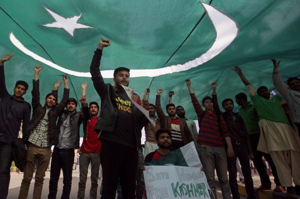 Students chant slogans under the shade of national flag, after Pakistan shot down two Indian military aircrafts, according to Pakistani officials, during a march in Lahore, Pakistan, 28 February 2019 (Photo: Reuters/Mohsin Raza).